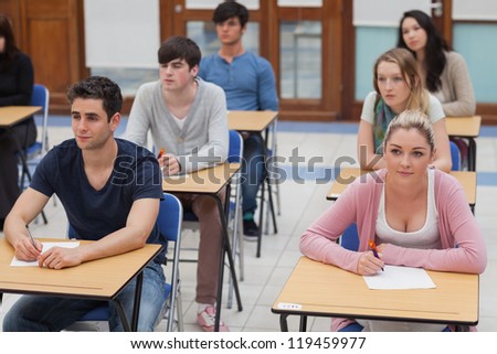 Students sitting in the exam room looking up