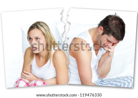 Angry couple sitting against each other in bed