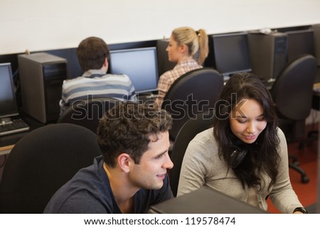 Four people in college computer class
