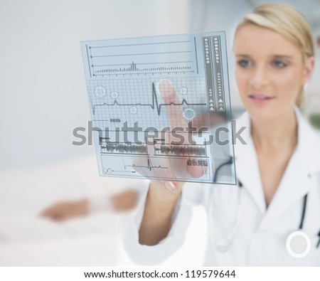 Doctor smiling and touching ECG interface hologram