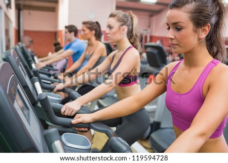 People exercising in the gym on exercise bicycles