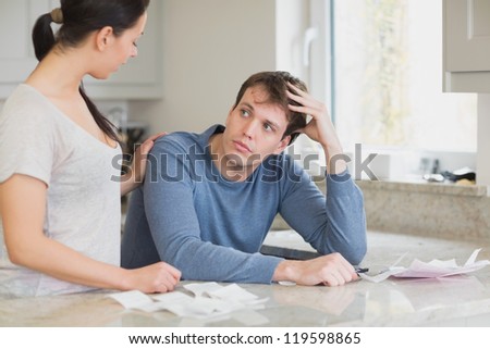 Two people in the kitchen are calculating the financial business