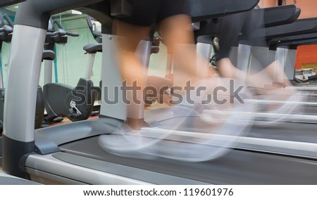 People jogging on a treadmill in the gym