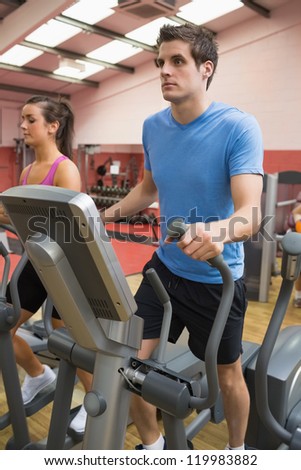 Man on step machine in gym