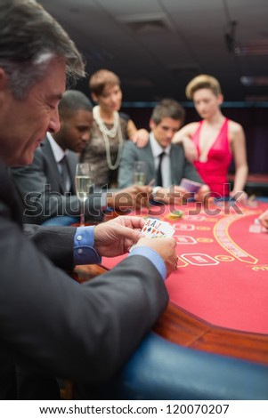 People playing at the poker table in casino