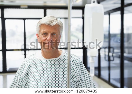 Patient standing in the corridor of the hospital with IV drip
