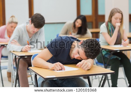 Man sleeping during exam in exam hall