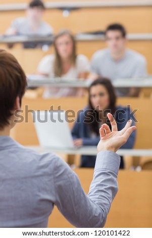 Teacher is talking to the students at the lecture hall