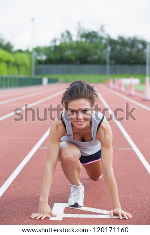 Woman starting to run on a track