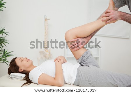 Serious brunette woman lying on a medical table in a room