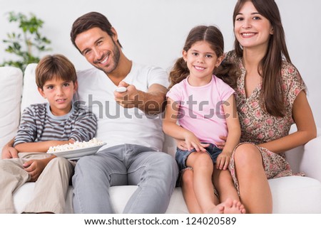 Happy family watching television together in the living room