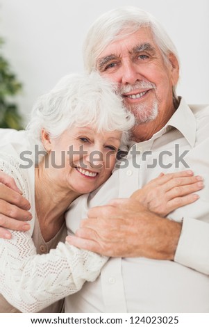 Elderly smiling couple on the couch