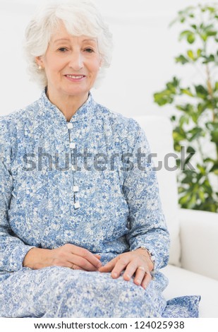 Aged woman sitting on sofa in the living room