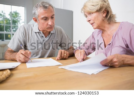 Couple discussing with documents on the table