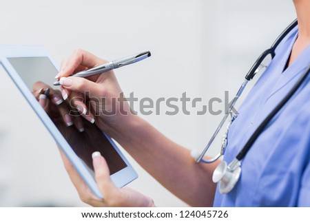 Close-up of female doctor using digital tablet