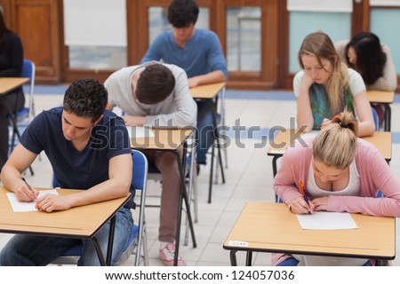 Students sitting a test in an exam hall in college