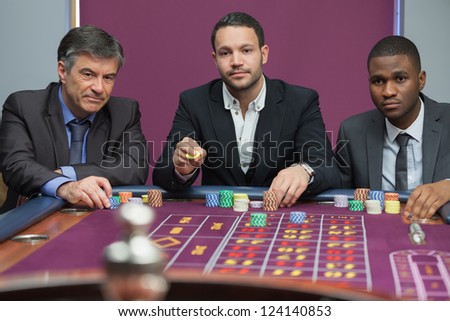 Three guys playing roulette in the casino