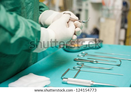Surgeon choosing a surgical instrument in an operating room