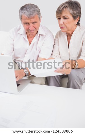 Old lovers not understanding the accounts and using laptop in sitting room