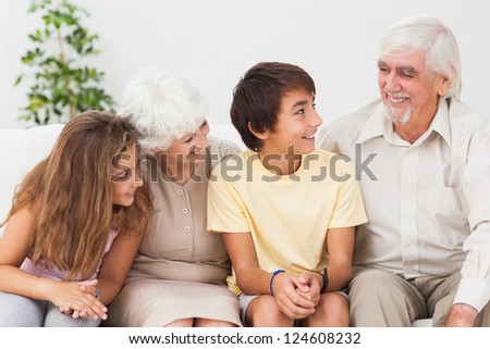 Grandparents with grandchildren chatting on the couch