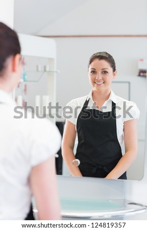 Portrait of a young confident hairdresser in hairdressing salon