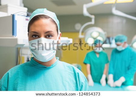 Female surgeon posing with her uniform in the operation theater