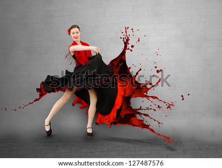 Flamenco dancer with dress turning into paint splashing on grey wall background