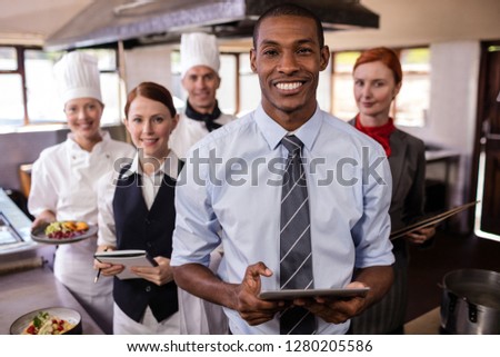 Group of hotel staffs working in kitchen at hotel