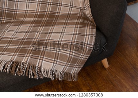Checkered blanket arranged on sofa
