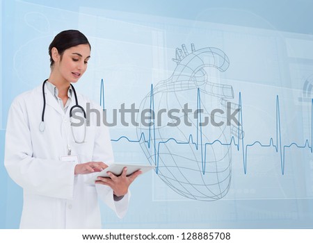 Cheerful cardiologist using a tablet pc in front of heartbeat line