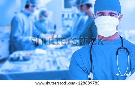 Surgeon standing with arms crossed