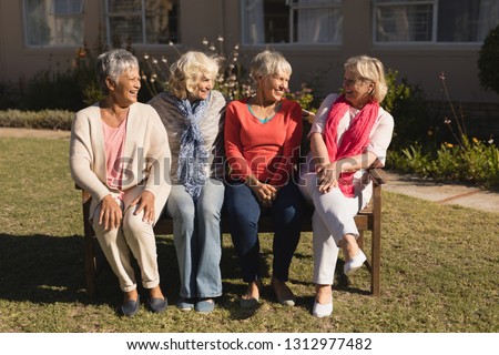 Front view of active and diverse group of senior women interacting with each other in the park