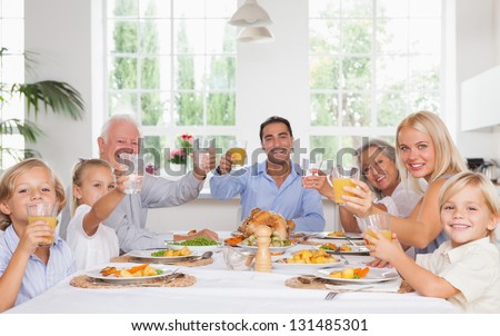 Happy Family Toasting Around The Table At Thanksgiving Dinner