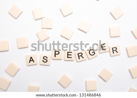 Asperger spelled out in plastic letter pieces on white background