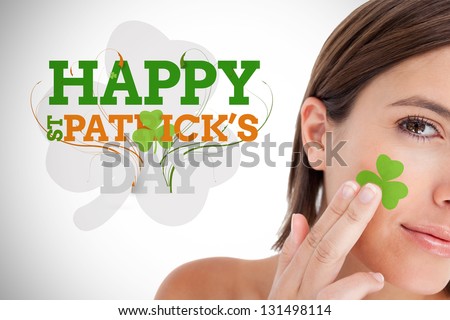 Saint patricks day greeting with smiling woman with shamrock on face