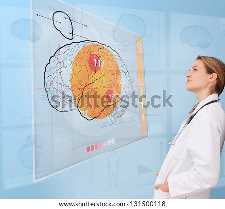 Thoughtful doctor using a futuristic interface for brain analysis