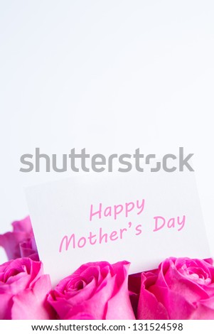 Bouquet of pink roses with happy mothers day card in pink on white background