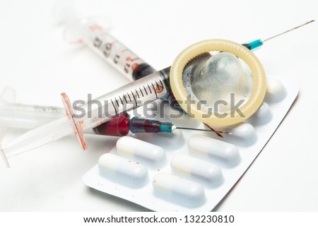 Hypodermic needle condom and medicine on white background