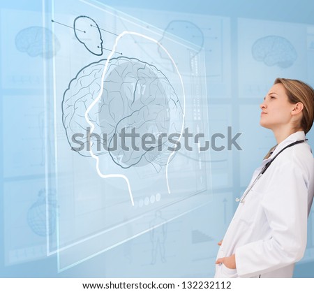 Woman doctor using a futuristic interface for brain analysis