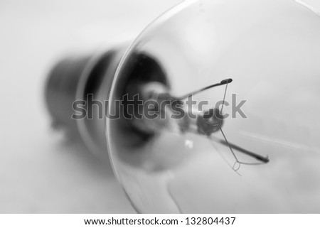 Clear light bulb in black and white close up