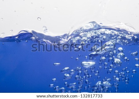Close up on blue sparkling water on white background