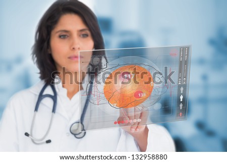 Female doctor touching a touchscreen in the hospital Female doctor touching a touchscreen in the hospital