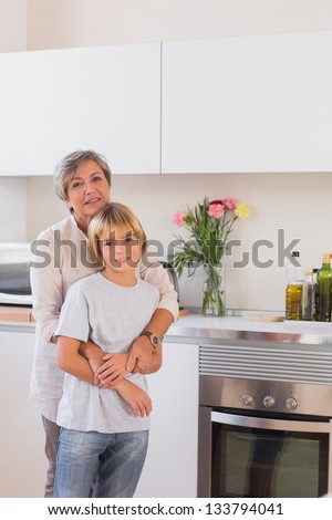Grandmother hugging her grandson in kitchen