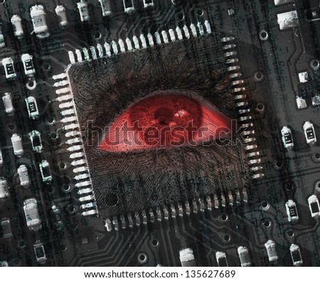Red eye looking up in middle of black circuit board