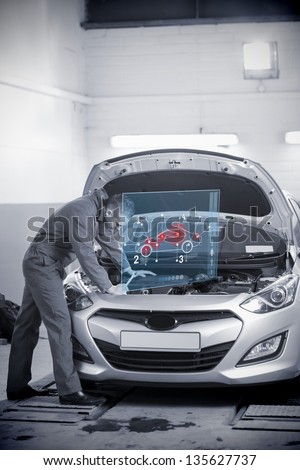 Man repairing car with open hood and futuristic interface showing map diagram