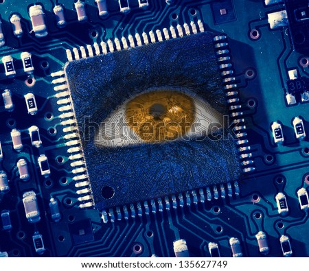 Brown eye looking up in middle of blue circuit board