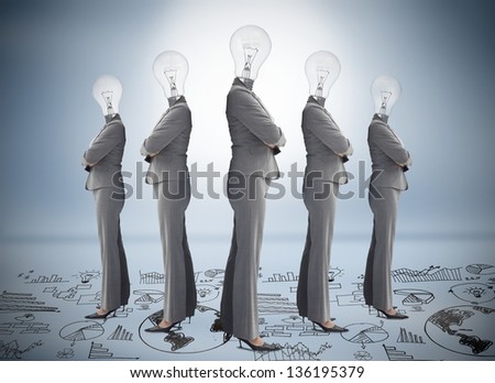 Businesswoman with bulb head multiplied standing on floor of graphs on blue background