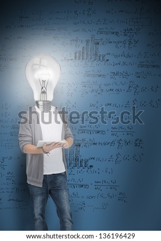 Boy with light bulb head lighting posing in front of blue board of maths problems
