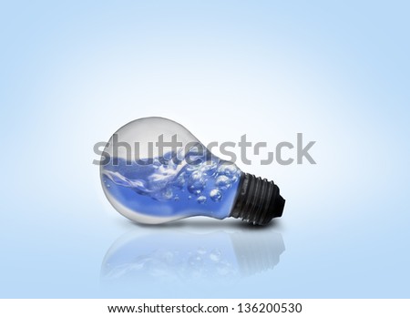 Blue water inside light bulb against blue background