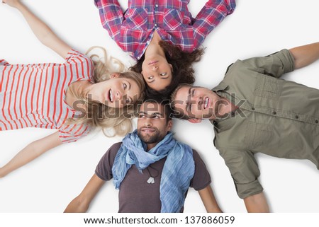 Overhead of friends lying in a circle on white background